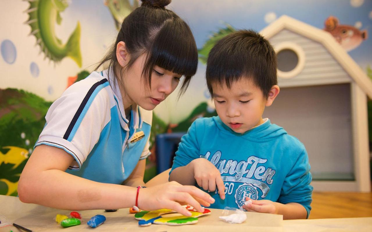 Caesar Park Hotel Kenting Exterior photo A child with autism being helped by a teacher